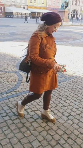 And such an ordinary walk of a modest girl with flowers in the old town square. [GIF] : video clip