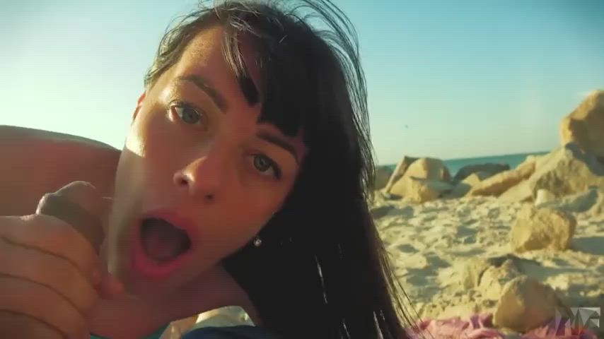 thick facial on a public beach : video clip