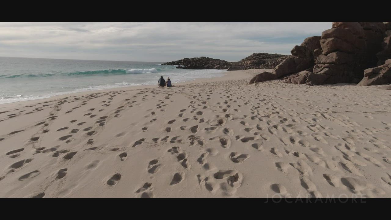 Another public beach handjob, with people in the distance... : video clip