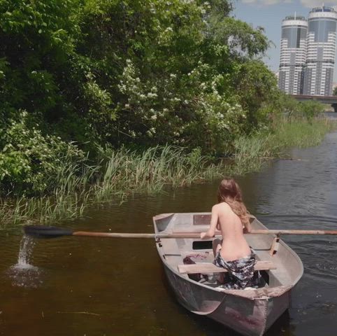 Mila Azul rows a boat in a public park [GIF] : video clip